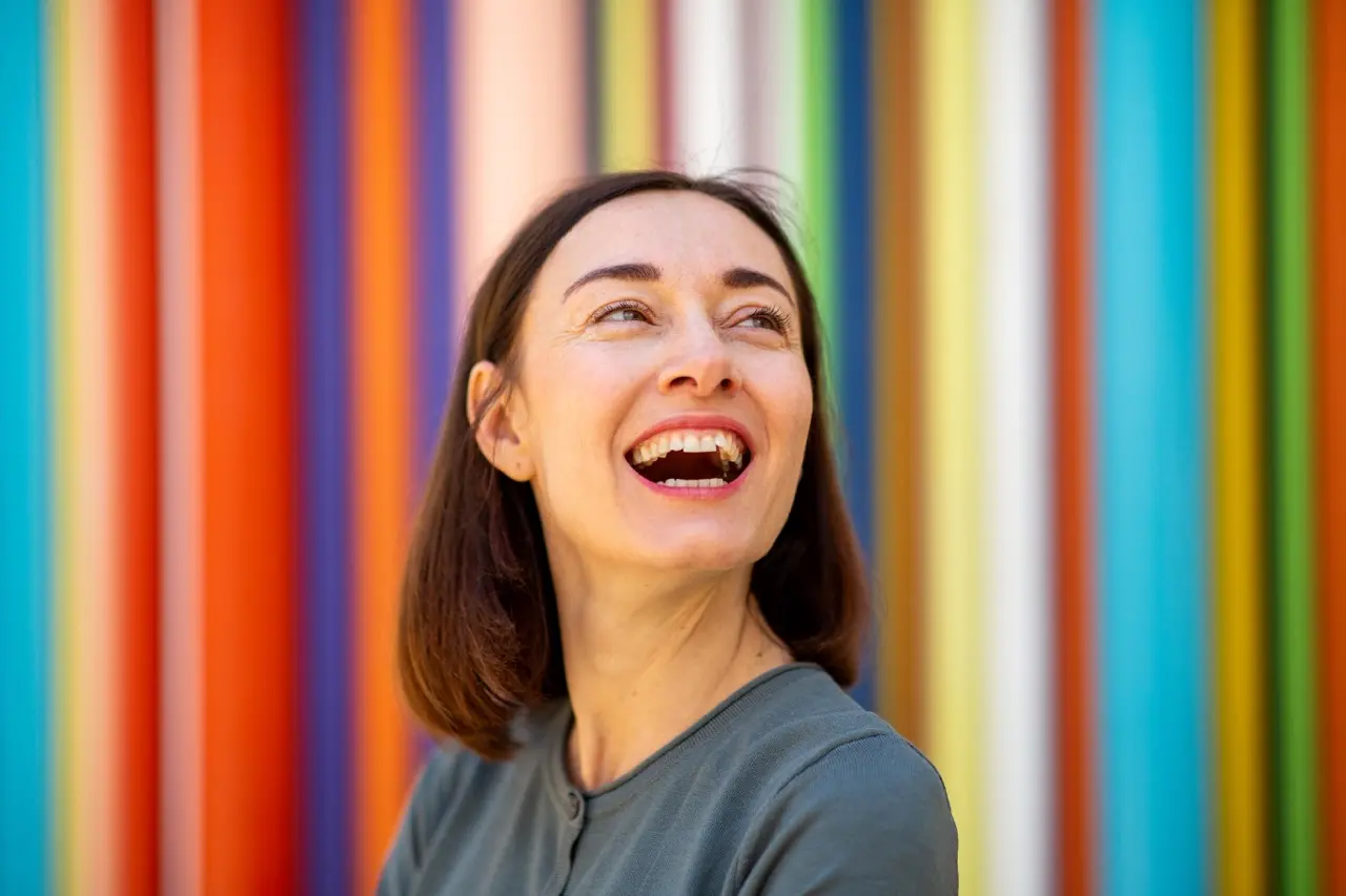 close up middle age woman laughing against colorfu 2026 01 05 05 06 45 utc Large | Voyager Recovery Center