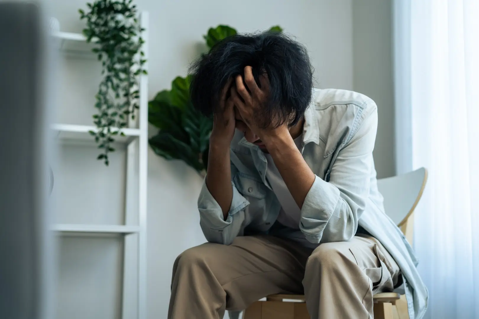 adult with head in hands sits indoor 2026 03 25 00 25 07 utc | Voyager Recovery Center