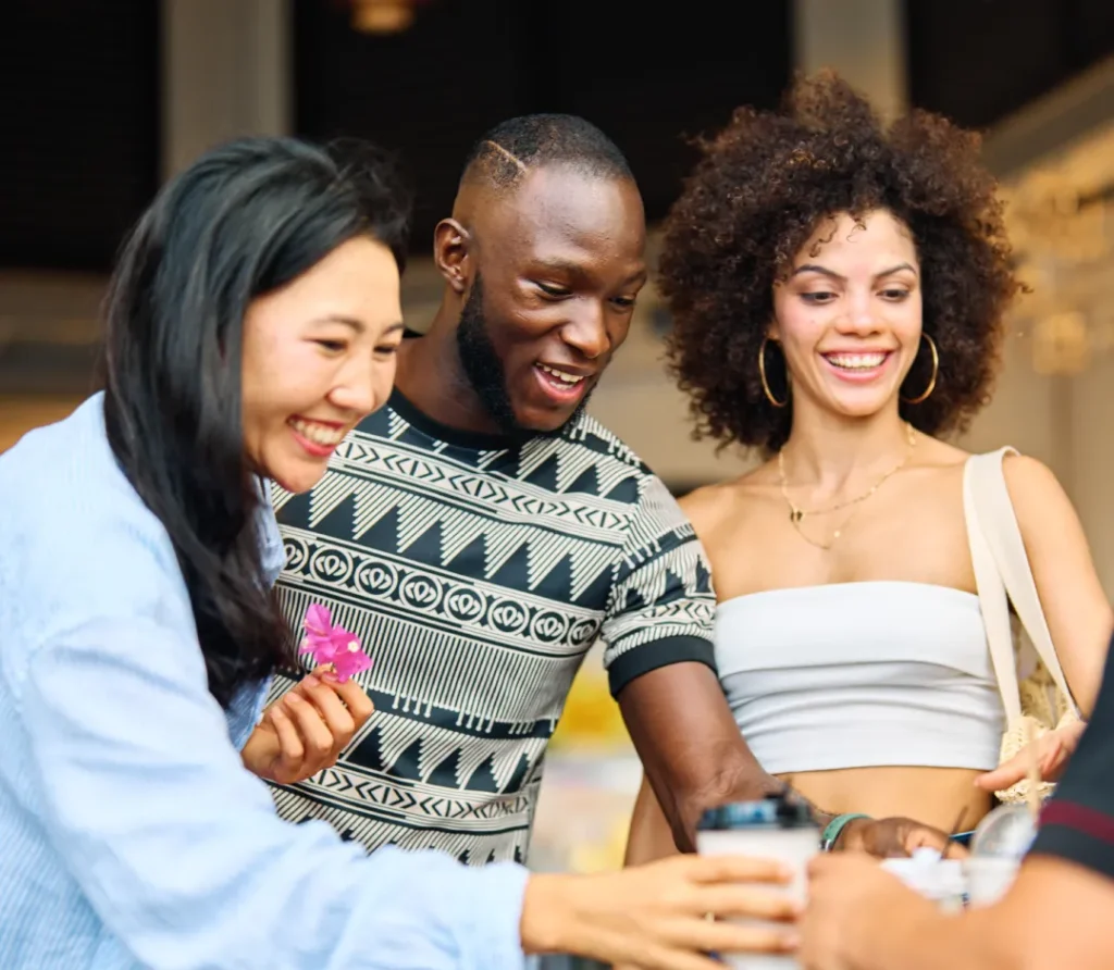smiling friends gather at outdoor cafe | Voyager Recovery Center